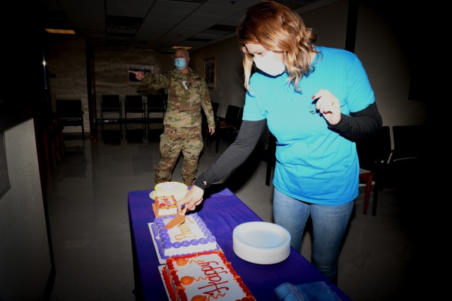 Dr. Melissa D. Rife, Raymond W. Bliss Army Health Center Chief of Pharmacy, cuts cake in the waiting room concluding Pharmacy Week activities. National Pharmacy week is October 18-24.