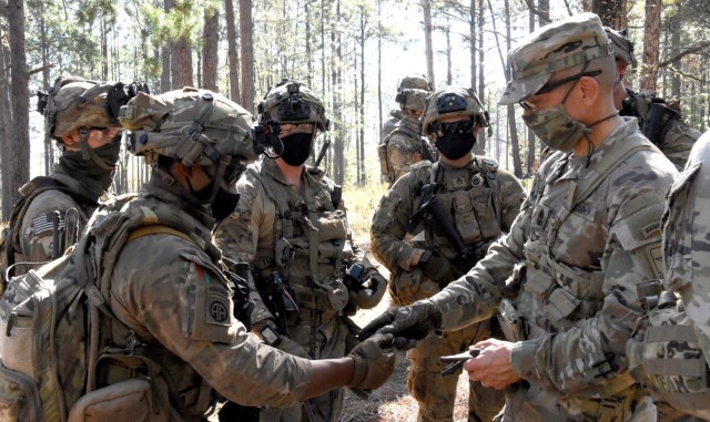 Sgt. Maj. of the Army Michael A. Grinston presents an SMA coin to Staff Sgt. Carlo Rodriguez, C Co, 1st Battalion, 21st Infantry Regiment, 25th Infantry Division, during Grinston’s visit to the JRTC Rotation 21-01 Oct. 21.