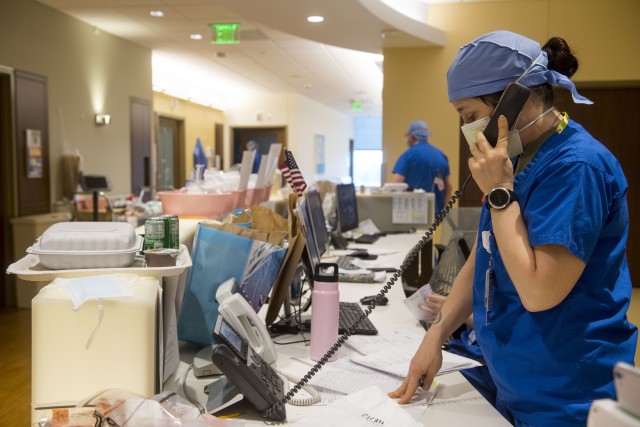 Maj. Kim Barron, an Army Reserve registered nurse with Urban Augmentation Medical Task Force 811-1, receives a phone call at Stamford Hospital-Bennett Medical Center, Stamford, Conn., April 27, 2020. The task force employed unique, expeditionary capabilities supporting the Department of Defense response to the COVID-19 pandemic. 
