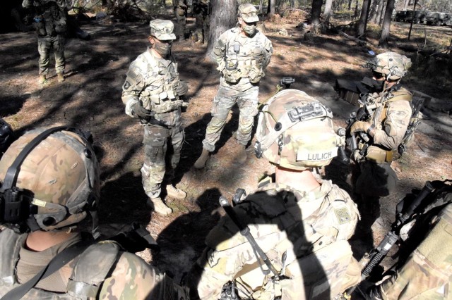 Sgt. Maj. of the Army Michael A. Grinston (second from left in the background) visits with Soldiers from C Co, 1st Battalion, 21st Infantry Regiment, 25th Infantry Division, during his visit to the Joint Readiness Training Center and Fort Polk...