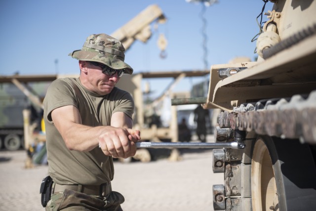 Spc. Adam Bartkowicz, an M1 Abrams tank system maintainer, tightens the track of an M88 Recovery Vehicle during the 1st Armored Brigade Combat Team, 34th Infantry Division&#39;s rotation at Fort Irwin, California&#39;s National Training Center, July 12, 2020. The checking and tightening of the track is part of the unit&#39;s daily preventative maintenance checks and services completed on all vehicles to ensure they are mission capable before entering &#34;the box.&#34;