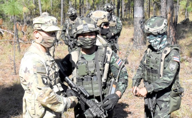 Sgt. Maj. of the Army Michael A. Grinston presents a member of the Royal Thai Army with an SMA coin.