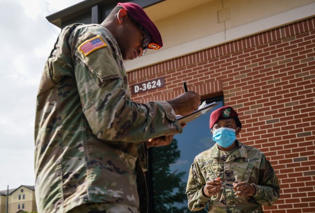 Sgt. Alleea Oliver, right, a public affairs mass communication specialist assigned to the 3rd Psychological Operations Battalion (Airborne) (Dissemination), helps a fellow Soldier register to vote through the Federal Voting Assistance Program as part of a voting registration drive at Fort Bragg, N.C., on October 13, 2020. The Federal Voting Assistance Program is a non-partisan government program administered by the Defense Department, designed to provide information, resources and tools to make voting easier for troops and family members living at home or abroad. (U.S. Army photo by Sgt. Liem Huynh)