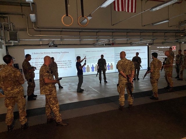 VICENZA, Italy - Headquartered at the town of Motta di Livenza, Italian army service members of the Multinational Civil-Military Cooperation Group hone their shooting skills Gun Fighter Gym on Caserma Del Din Oct. 1, 2020. Joe Lynch (center), site...