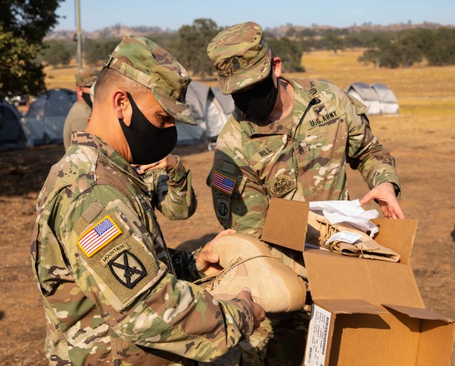 Command Sgt. Maj. Phil Barretto, U.S. Army North Command Sergeant Major, (left) inspects the fire resistant boots issued to soldiers of the 14th Brigade Engineer Battalion during his visit to Stonyford, California, Sep. 1, 2020. The 14th BEB is...