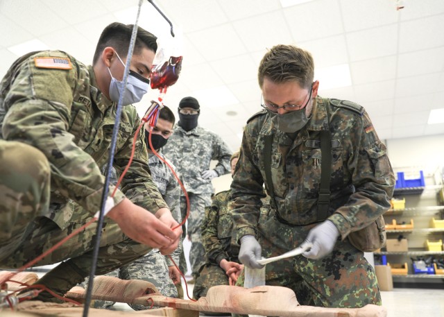 U.S. Army Spc. Andres Reta, oversees Bundeswehr (German Armed Forces) Navy Lt. Oswald Oliver, apply a pressure dressing on a simulated casualty as part of the International Trauma Combat Casualty Care course at Landstuhl Regional Medical Center, Oct. 2. The international course, which included Service Members from four Nations, was aimed at providing unit-level health care providers life-saving instruction to increase survivability at the point of injury.