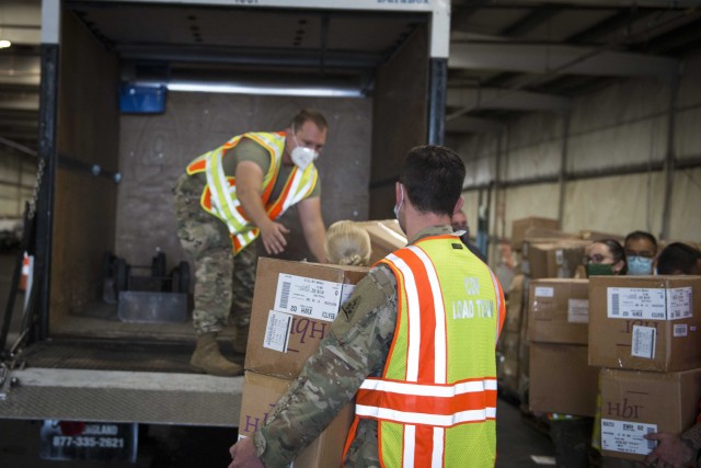 Soldiers and Airmen from the Connecticut National Guard load boxes of face masks into a vehicle at West Hartford Public Works, West Hartford, Conn., Sept. 30, 2020. The Connecticut National Guard is helping the state Department of Education and Division of Emergency Management and Homeland Security distribute 600,000 masks to school districts throughout the state. 