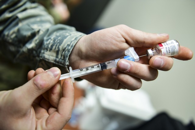 A medical technician prepares a vaccine at the Pittsburgh International Airport Air Reserve Station, Pa., April 11, 2019. While U.S. military personnel will not be directly involved in handling or moving COVID-19 vaccines for the nation, their expertise in logistics will be involved in making sure every American has access to vaccines.