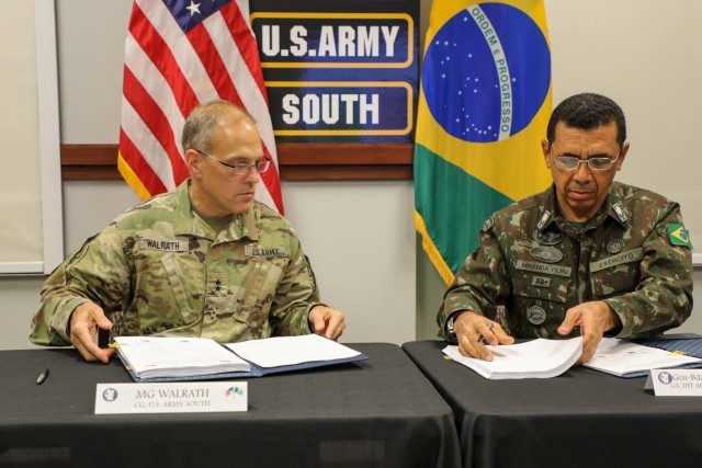 Maj. Gen. Daniel R. Walrath (left), U.S. Army South commanding general, and General de Brigada Otávio Rodrigues de Miranda Filho, 5th deputy chief of staff for the Brazilian Army, sign documents to approve agreed-to-actions and a five year plan...