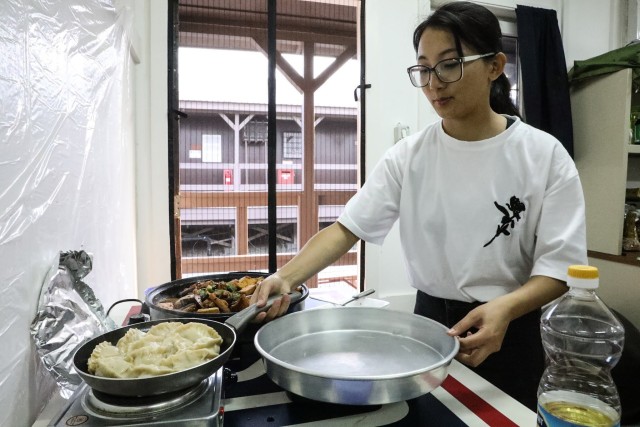 A soldier cooks an Asian inspired dish to help boost morale of the soldiers, supporting the U.S.-led Kosovo Force Regional Command East in it’s 27th rotation at Camp Bondsteel, Kosovo, during the COVID-19 pandemic.