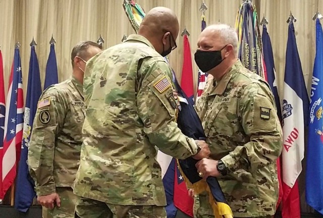 Maj. Gen. Bruce Hackett (right) relinquishes his command of the 80th Training Command (The Army School System) by passing the command’s colors to Maj. Gen. A.C. Roper, the U.S. Army Reserve’s deputy commanding general, during a ceremony at...