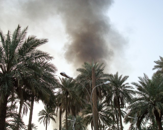 Smoke billowing above the palm trees after an attack on the Green Zone in March 2008, at the same compound where Purple Heart recipient Army Col. Fred Heaggans was injured a month later. At the time Heaggans was the U.S. Army Security Assistance Command liaison officer for the Multi-National Security Transition Command in Baghdad, Iraq, assisting them with managing foreign military sales cases. (Courtesy photo)