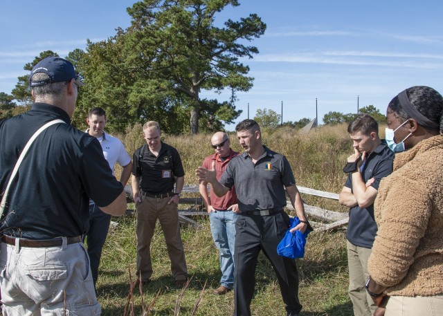 Command Sgt. Maj. Daniel T. Hendrex, U.S. Army Training and Doctrine Command senior enlisted advisor (center) discusses the events that took place 239 years prior and how those lessons learned can be applied today in terms of Soldier resiliency during a staff ride at the Yorktown, Va., Battlefields Oct. 19, 2020. The staff ride was a reward for the nation’s top performing Army recruiters and drill instructors with a primary focus on resiliency and mentorship. (U.S. Army photo by David Overson)