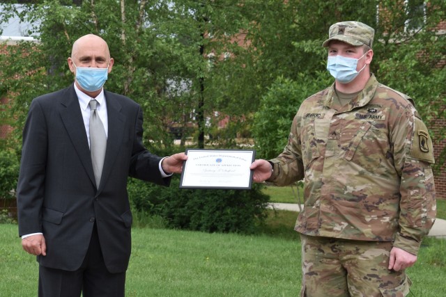 John Lowry, Assistant Secretary of Labor, Veterans Employment and Training Services at the Department of Labor, recognizes Cpl. Zachary Stafford for his contributions while serving as an intern with the DoL's VETS office from February through June of 2020. (Photo credit: Laurel Devine)