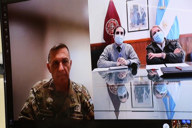 Argentine Army Col. Oscar Zarich, Argentine Partner Nation Liaison Officer, U.S. Army South, left, moderates a COVID-19 subject matter expert exchange between doctors from the Argentine Army and Brooke Army Medical Center, Oct. 21, 2020. The video teleconference consisted of a panel of medical professionals discussing lessons learned to provide a compilation of best practices in response to the COVID-19 pandemic and other health-related topics. (U.S. Army photo by Robert A. Whetstone)
