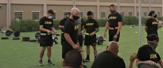 Staff Sgt. Eric Smith, G3 training noncommissioned officer, 1st Theater Sustainment Command, instructs Soldiers from the 311th Expeditionary Sustainment Command, 3rd Medical Command, 401st Army Field Support Brigade, and the 304th Sustainment Brigade on the grader requirements for the Army Combat Fitness Test at the Area Support Group-Kuwait Field Oct. 6, 2020 at Camp Arifjan, Kuwait. Smith and the 1st Theater Sustainment Command are responsible for ACFT familiarization and grader validation during the month of October ensuring readiness for the Army units currently serving at Camp Arifjan.  (U.S. Army Photograph by Spc. Andrew E. Figueroa)