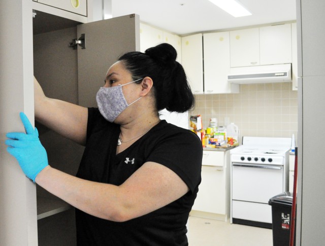 Jo Messerle, owner of DustBusters cleaning service, cleans the home of a moving Soldier on Camp Zama, Japan, Oct. 27.