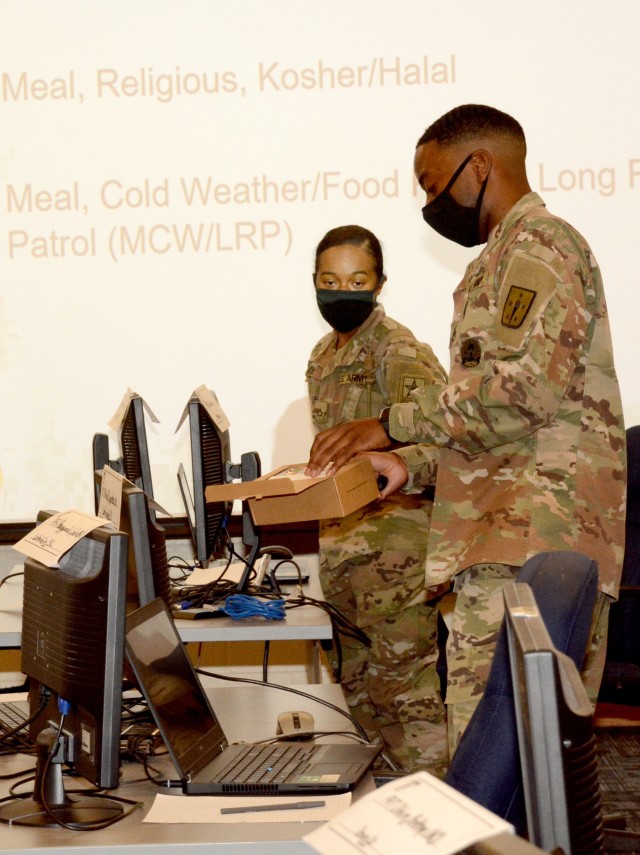 FORT LEE, VA. - Instructor of the Year candidate Staff Sgt. Terrence Reid shows a student a Kosher/Halal meal during a class on subsistence that was evaluated on the second day of the week-long IOY competition that continues through Friday. The...