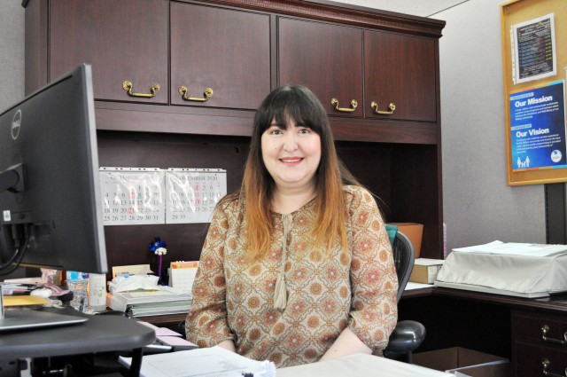 Rika Osada, business and nonprofit liaison for the Non Appropriated Fund Support Management Division of Camp Zama’s Family and Morale, Welfare and Recreation, poses for a photo in her office at Camp Zama, Japan, Oct. 26.