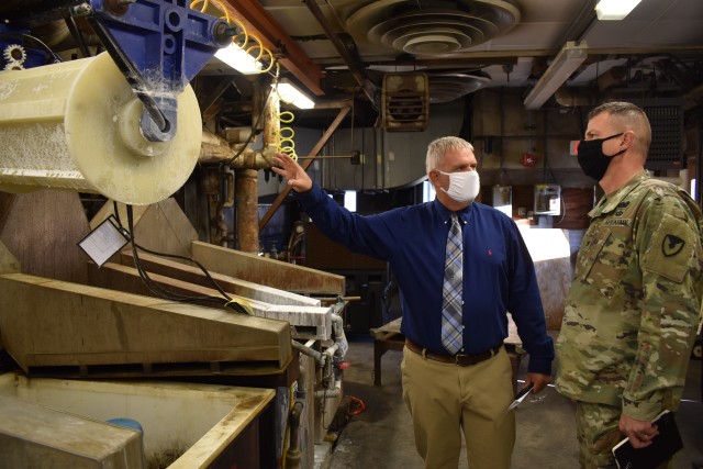 Old to New: Joint Munitions Command Commander Col. Gavin Gardner is briefed on how Crane Army Ammunition Activity is modernizing its original WWII-era plating facility, seen here, during a visit on October 15, 2020. A modernized plating facility, planned to be operational in February, will utilize advanced technology to more accurately measure how much water is needed to support the chemical reaction that bonds a corrosive resistant coating to metal components in munitions. CAAA is one of 17 installations of the JMC and one of 23 organic industrial bases under the U.S. Army Materiel Command, which include arsenals, depots, activities and ammunition plants. (U.S. Army photo by Hayley Smith)