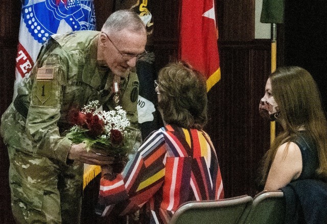 Maj. Gen. A. “Ray” Royalty presents flowers to his wife, Teena, during his retirement ceremony Oct. 27, 2020. Royalty has retired after 37 years of service.