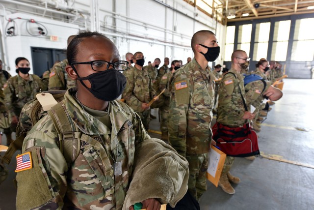 Soldiers stand in formation inside a hangar at Kelly Field during a layover as they travelled from Fort Jackson to Fort Huachuca. They were on a chartered flight along with Soldiers that also departed Fort Jackson to begin training at the U.S. Army Medical Center of Excellence.