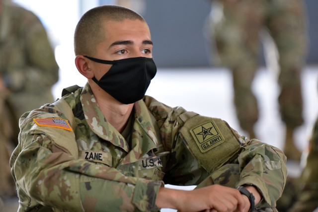 A Soldier waits in a hangar at Kelly Field after arriving to San Antonio from Fort Jackson to begin advanced individual training at the U.S. Army Medical Center of Excellence.
