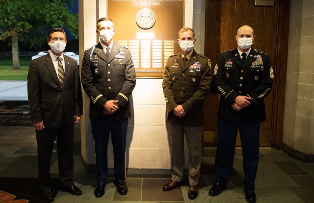 Maj. John A. Meyer (second from left), U.S. Military Academy Class of 2005, stands with the Commandant of Cadets  Brig. Gen. Curtis A. Buzzard (second from right), Association of Graduates President Todd Browne and U.S. Corps of Cadets Command Sgt. Maj. Kenneth Killingsworth Oct. 22 in front of the Alexander R. Nininger plaque.