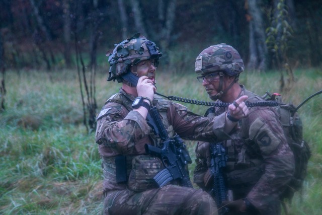 U.S. Army Capt. Daniel Pedersen, company commander, Company D, 1st Battalion, 506th Infantry Regiment &#34;Red Currahee&#34;, 1st Brigade Combat Team, 101st Airborne Division, left, directing his platoon on the radio with his Radio Telephone Operator, U.S. Army Capt. Rodolfo Garcia, artilleryman, 2nd Battalion, 32nd Field Artillery Regiment &#34;Proud Americans&#34;, 1st Brigade Combat Team, 101st Airborne Division during the 26-hour tactical training portion of Bastogne Forge Oct. 28 in Dahlonega, Ga. The Bastogne Forge exercise took the leadership within 1BCT, 101st Abn Div. on a five day leader development exercise to strengthen bonds through shared hardship and gain a greater understanding of their unit history.