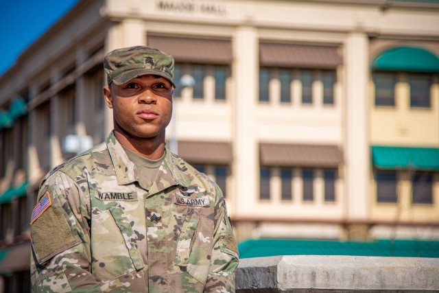 CAMP HUMPHREYS, South Korea - Sgt. Brennan M. Wamble, an air traffic control operator assigned to Headquarters and Headquarters Company, United States Army Garrison - Humphreys and a native of Chicago, poses outside of Maude Hall, the headquarters...