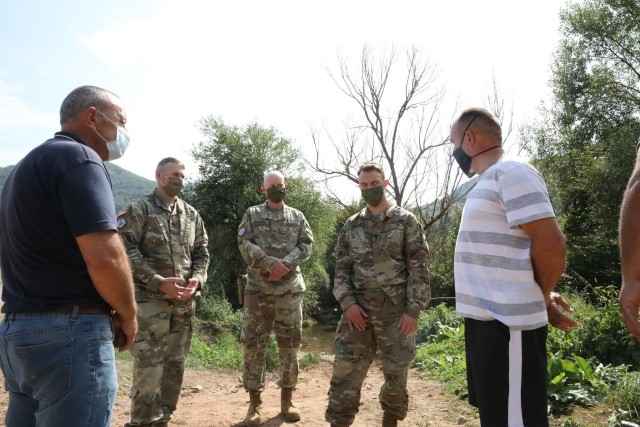 STREZOVCE/STREZOFC, Kosovo--- KFOR Regional Command East Soldiers follow a local subsistence farmer on a half-mile trek the village water source and brace themselves as they cross a narrow rickety foot bridge made of wooden planks and clutch the...
