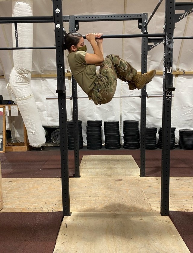 Supply Specialist Spc. Gianna Polizzi, Chicago resident, practices the leg tuck event in the U.S. gym at Collective Training Center-Yavoriv, Ukraine Oct. 21. (Photo by U.S. Army Cpl. Alyssa Artola)