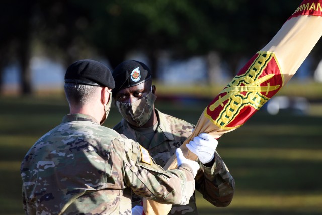 Garrison Command Sgt. Maj. Algrish C. Williams Sr., receives the Fort Jackson Garrison colors from Col. John "Wes" Hankins, garrison commander, during an assumption of responsibility ceremony Oct .23 at Victory Field.