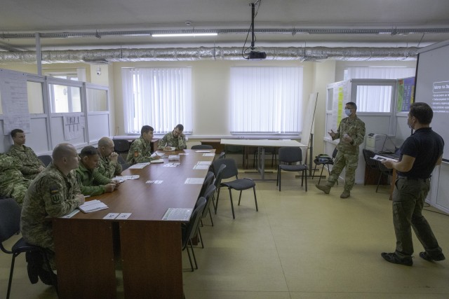 Cpt. Joshua Palacios conducts a wargaming seminar with Ukrainian Army Advisors in attendance Oct. 6. (Photo by Sgt. Gregory Glosser, Task Force Illini Public Affairs.)