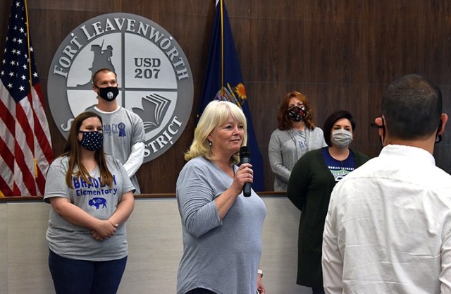 Colleen Toliver, Bradley Elementary School first-grade teacher, addresses Bradley staff and faculty who are watching via live stream from Bradley auditorium while her fellow teachers look on during the award ceremony honoring Bradley being named...