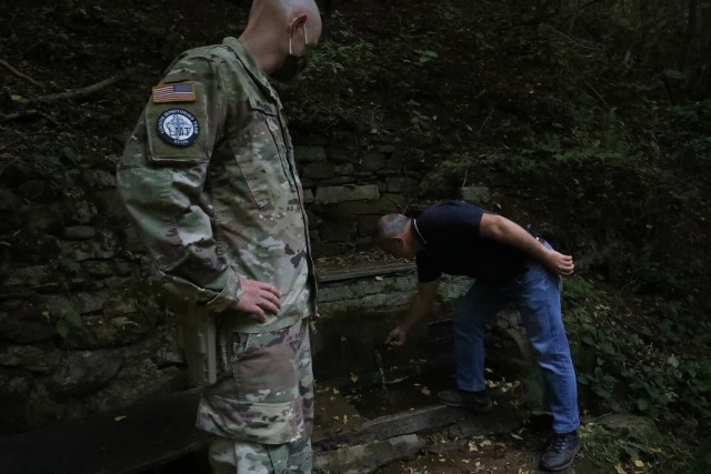 STREZOVCE/STREZOFC, Kosovo--- KFOR Regional Command East Soldiers follow a local subsistence farmer on a half-mile trek the village water source and brace themselves as they cross a narrow rickety foot bridge made of wooden planks and clutch the...