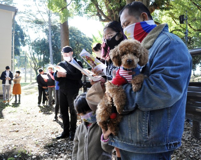 Joey Escalante holds Kou’na, a toy poodle, during the Holy Family Catholic Community St. Francis Blessing of the Pets and Animals, Camp Zama, Japan, Oct. 31.