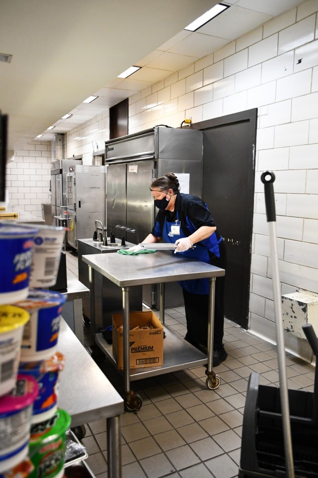 Patricia Redman, a Geronimo Warrior Restaurant dining facility attendant, works to sanitize and clean Geronimo Warrior Restaurant Oct. 27, after breakfast and before the lunch rush.