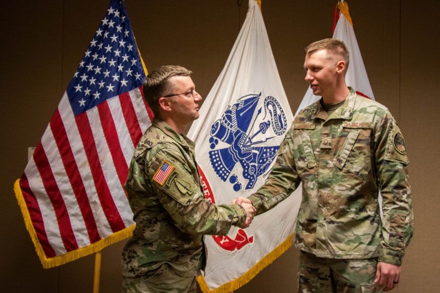 U.S. Air Force Master Sgt. John Crowley (right) shakes hands with Denver Army Recruiting Battalion Commander, Lt. Col. Michael Oleson, (left), after returning from the Military Enlistment Processing Station Oct. 23, 2020 at the Denver Recruiting...