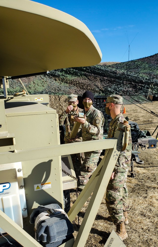 (From left to right) Pvt. 1st Class Bryton Lunceford, Spc. Kevin Jones, and Spc. Christopher Vorwaller, Soldiers assigned to the 217th Brigade Signal Company, Utah National Guard, prepare to level a satellite communication terminal at a mobile...