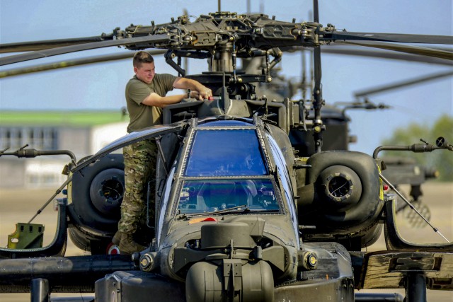 A U.S. Soldier with D Company, 1st Battalion, 3rd Aviation Regiment (Attack Reconnaissance), 12th Combat Aviation Brigade, conducts routine maintenance on a AH-64 Apache helicopter on Aug. 29, 2018, at Katterbach Army Airfield in Ansbach, Germany. 