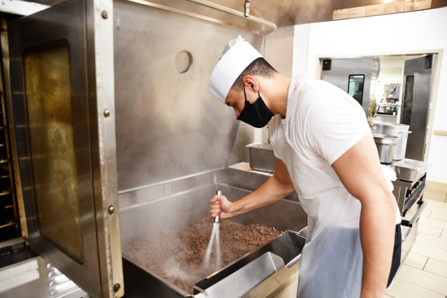 Spc. Rafael Caraballo Rodriguez, Patriot Warrior Restaurant culinary specialist, stirs taco meat in the Patriot Warrior Restaurant kitchen Oct. 27.