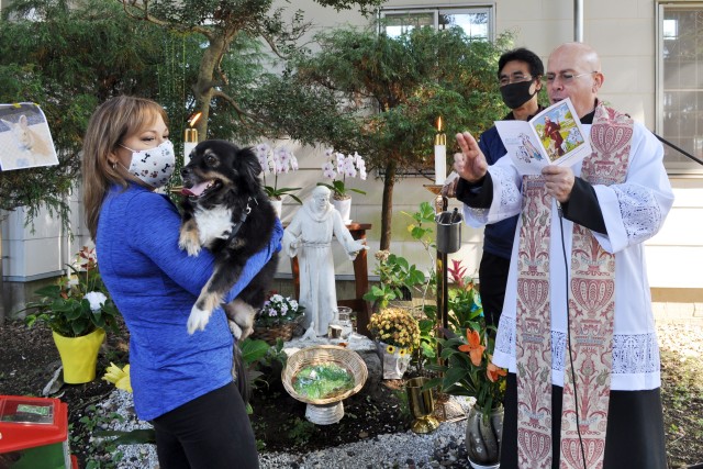 Chaplain (Lt. Col.) Alan Irizarry, operations chaplain for U.S. Army Japan and a Catholic priest, prays for pets and their families in a garden next to Camp Zama Chapel during the Holy Family Catholic Community St. Francis Blessing of the Pets and...