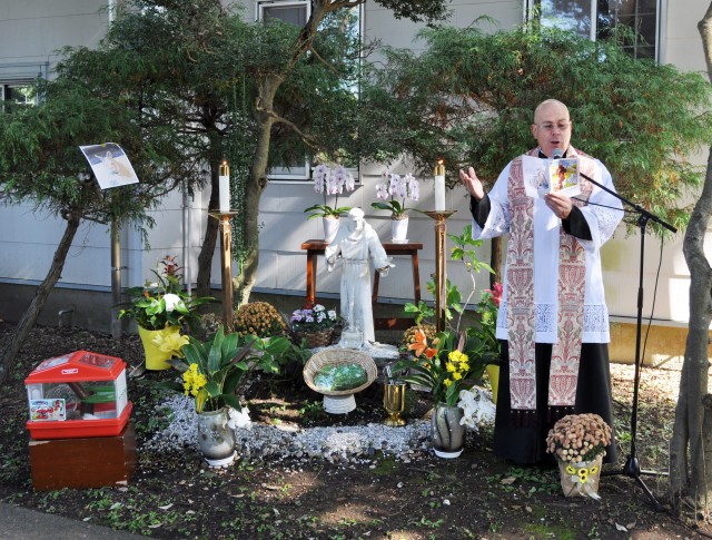 Chaplain (Lt. Col.) Alan Irizarry, operations chaplain for U.S. Army Japan and a Catholic priest, prays for pets and their families in a garden next to Camp Zama Chapel during the Holy Family Catholic Community St. Francis Blessing of the Pets and...