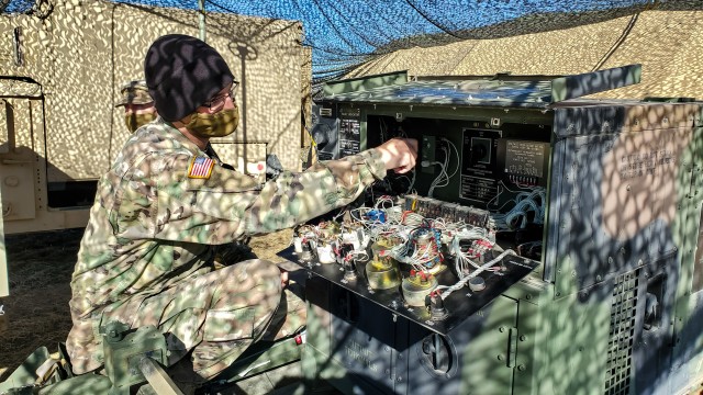 Spc. Kevin Jones, a satellite communications operator assigned to the 217th Brigade Signal Company, Utah National Guard, gets ready to start a field generator at a mobile tactical operations center during a Warfighter Exercise at Fort Carson,...