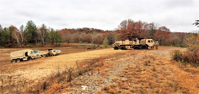 Soldiers at Fort McCoy, Wis., for training in the Regional Training Site-Maintenance Wheeled-Vehicle Recovery Operations Course work together during training Oct. 23, 2020, at the installation Vehicle Recovery Site on North Post. The 17-day course...