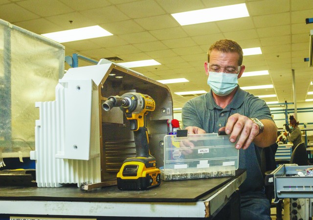 Shannon Arrowood assembles a Redesigned Turret Network Box in Anniston Army Depot&#39;s Laser/Thermal Electronics Branch.