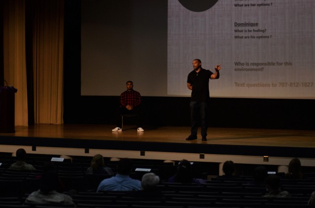 Dominique Waltower, motivational speaker and life development coach, speaks during a Domestic Violence Awareness month event Oct. 30 in Carey Theater on Joint Base Lewis-McChord.