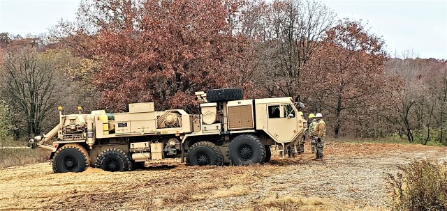 Soldiers at Fort McCoy, Wis., for training in the Regional Training Site-Maintenance Wheeled-Vehicle Recovery Operations Course work together during training Oct. 23, 2020, at the installation Vehicle Recovery Site on North Post. The 17-day course...
