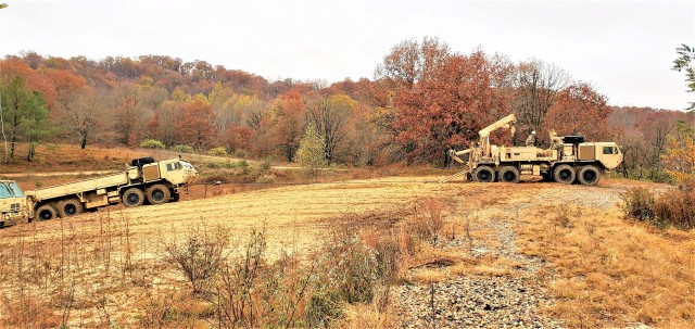 Soldiers at Fort McCoy, Wis., for training in the Regional Training Site-Maintenance Wheeled-Vehicle Recovery Operations Course work together during training Oct. 23, 2020, at the installation Vehicle Recovery Site on North Post. The 17-day course...